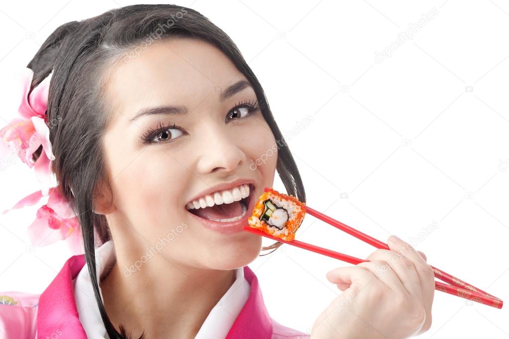 Happy Woman Eating Sushi with Chopsticks