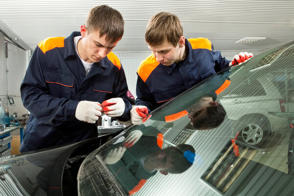 Two Real Mechanics working in Auto Repair Shop