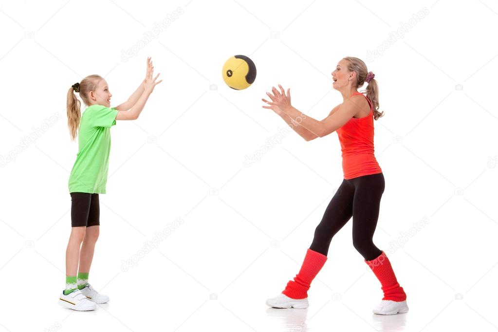 Little girl doing exercise with an instructor