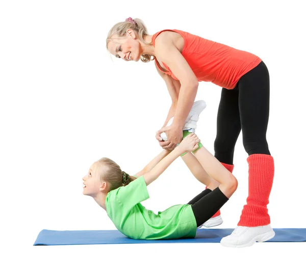 Little girl doing exercise with an instructor — Stock Photo, Image