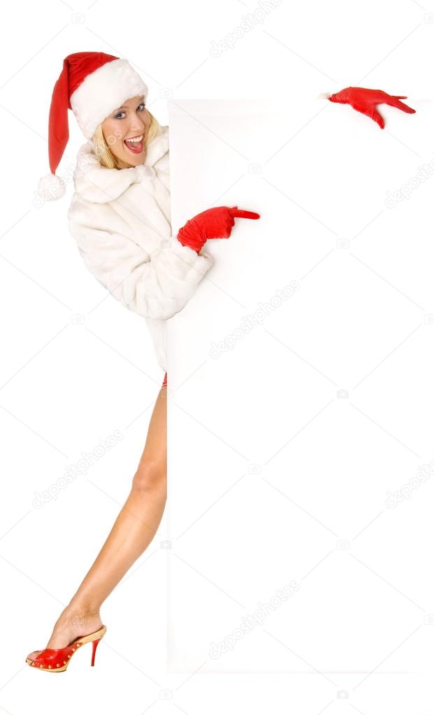 Sexy Girl dressed as Santa Claus Points Finger to Copy Spaces