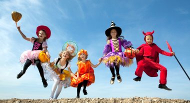 Five Halloween Children Jumping at the Blue Sky