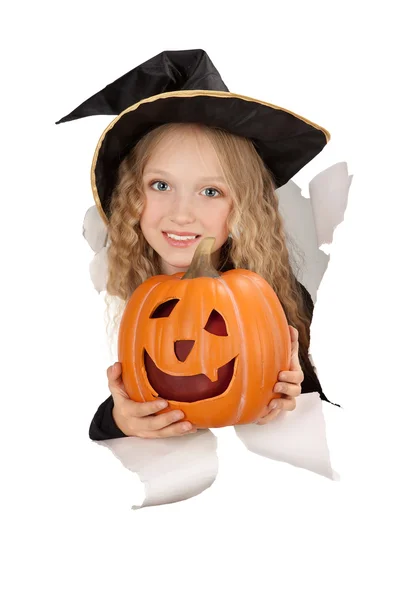 Breakthrough little witch holding a pumpkin — Stock Photo, Image