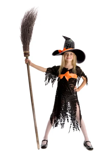Little happy witch holding a broom. — Zdjęcie stockowe