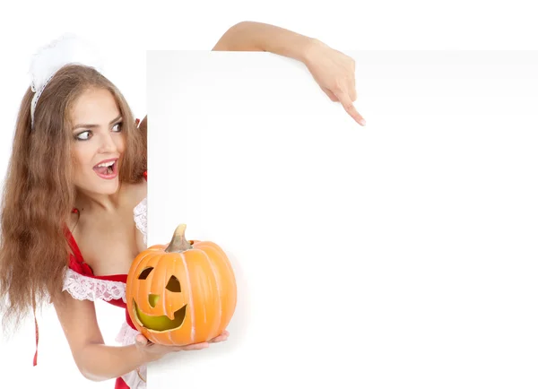 Beautiful young woman in a costume of sexy waitress pointing the sign — Stockfoto