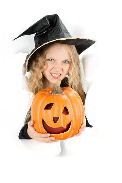 Little witch peeking through a hole in white paper — Stock Photo, Image