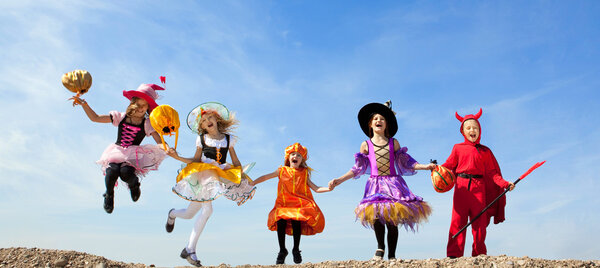 Five Halloween Children Jumping at the Blue Sky.