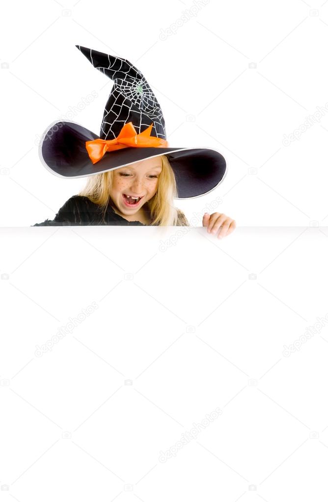 Little funny witch holding a sign