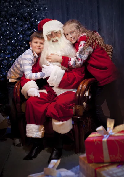 Clásico Santa dando regalos de Navidad a niños felices . —  Fotos de Stock
