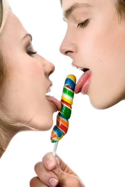 Happy Young Couple Licking a Lollipop — Stock Photo, Image