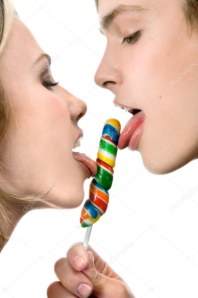 Happy Young Couple Licking a Lollipop