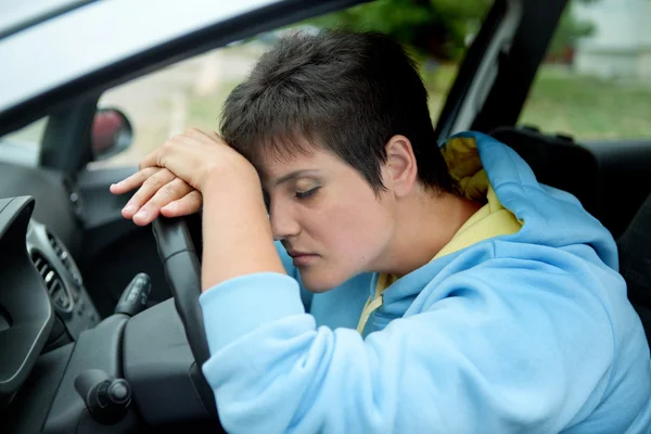 Beautiful Young Woman Sleeps in the Car - Outdoors