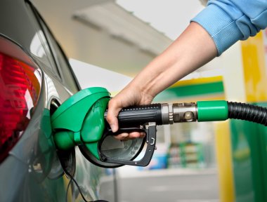 a Arm Refueling the Car at a Gas Station clipart