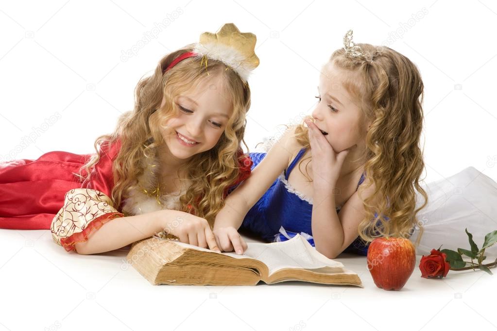 Two Happy Little Princesses Reading a Magic Book 