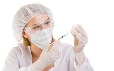 Kadın bilimci bir şırınga ve bir yumurta kullanarak bir aşı hazırlama