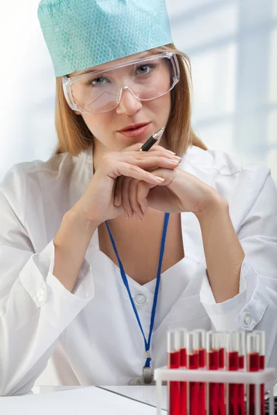 Young Woman Scientist Explores the Blood in the Tube Examining a