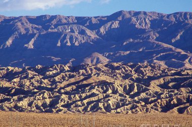 San Andreas Geologic Fault Line in Coachella Valley, California, USA.  Near Palm Springs at sunrise the North American Continental Plate meets the Pacific Continental Plate right where the ground juts up from the desert floor. clipart