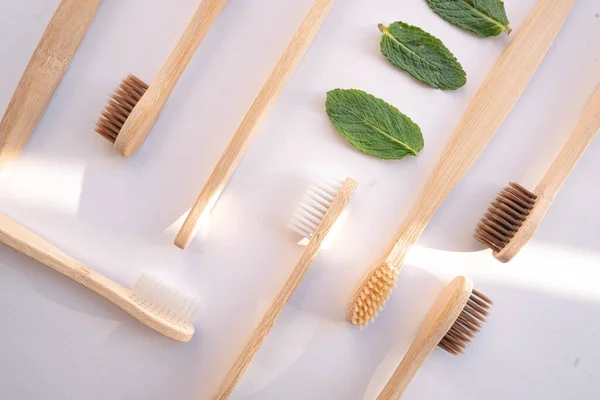 Zero waste bamboo toothbrush on white background with mint leaf — Stock Photo, Image