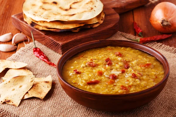 Thick indian red lentil soup with cilantro served with indian flat bread. — Stock Image Thick indian red lentil soup with cilantro served with indian flat bread. Royalty Free Stock Photos