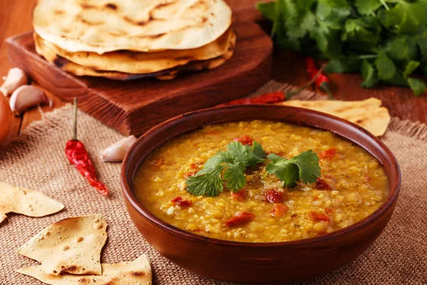 Thick indian red lentil soup with cilantro served with indian flat bread. — Stock Image Thick indian red lentil soup with cilantro served with indian flat bread. Royalty Free Stock Photos