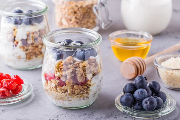 Healthy breakfast - glass jars of oat flakes with fresh fruit, y