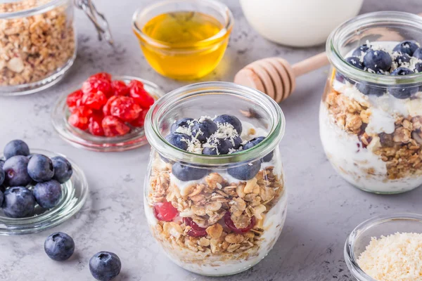 Healthy breakfast - glass jars of oat flakes with fresh fruit.