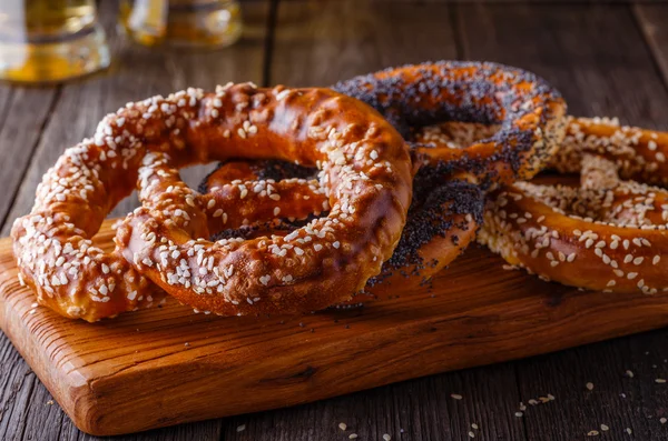 Pretzels and beer on a wooden background.