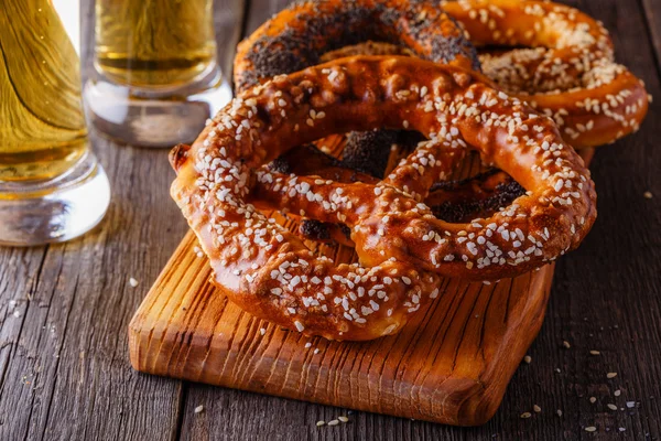 Pretzels and beer on a wooden background.