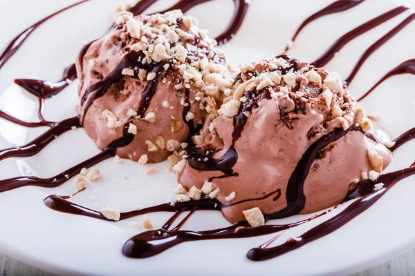 Chocolate ice cream with cashews and chocolate syrup
