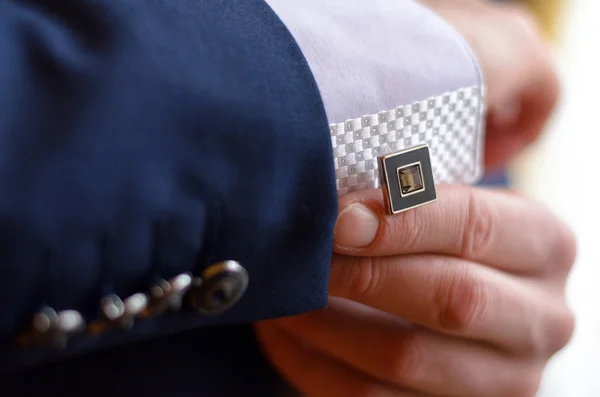 A man fastens a cuff-link — Stock Photo, Image