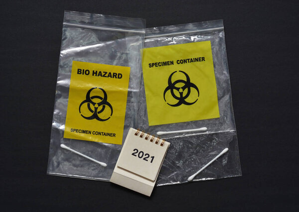 Bio Hazard Specimen Zip Lock Bag And White Calendar 2021 On Dark Background. Health Care Concept