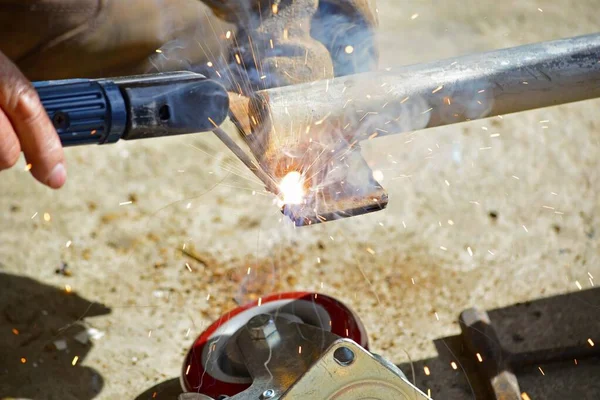 Worker Welding Machine Fixing Caster Wheels Fiery Sparks Flying — Stock Photo, Image