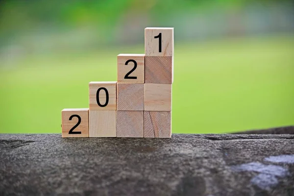 2021 number on wooden block with blurred background. 2021 new year concept