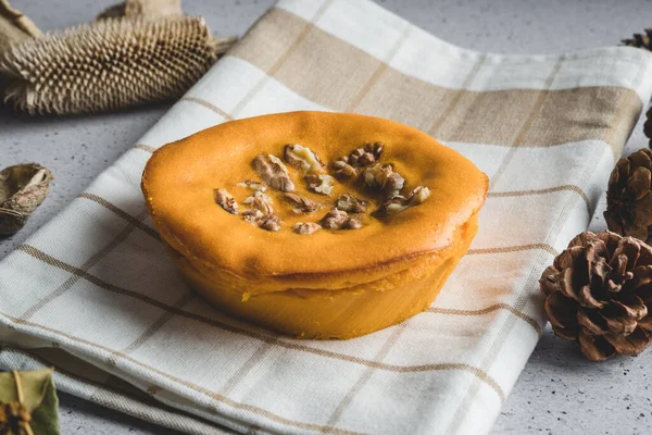 Sweet potato cake with walnuts decorated with dry leaves