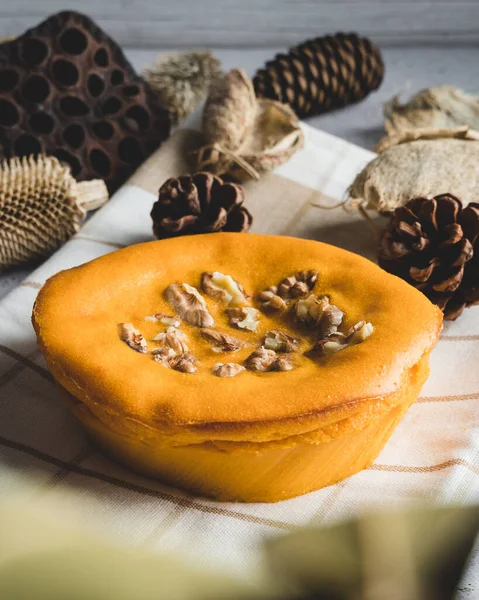 Sweet potato cake with walnuts decorated with dry leaves