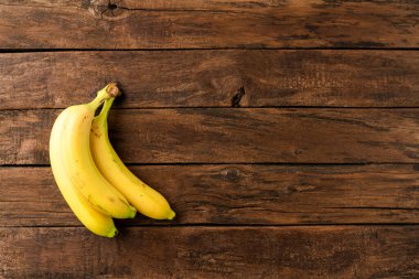Ahşap zemin üzerinde muz demeti. Meyve arkaplanı