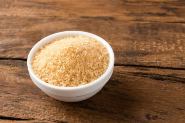 Esmer kamış şekeri eski ahşap arka planda kasede