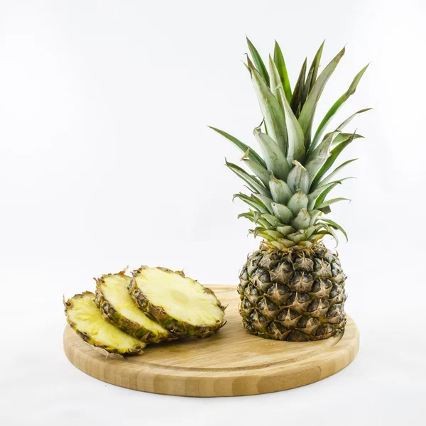 Cut and sliced pineapple on wooden board isolated on wihte. — Stock Photo, Image