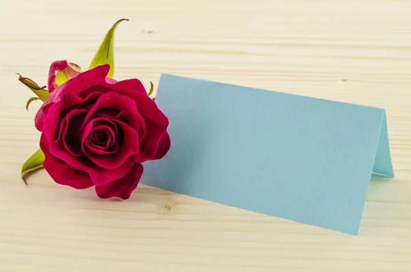 Rose flower with blank invitation card on wooden background — Stock Photo, Image