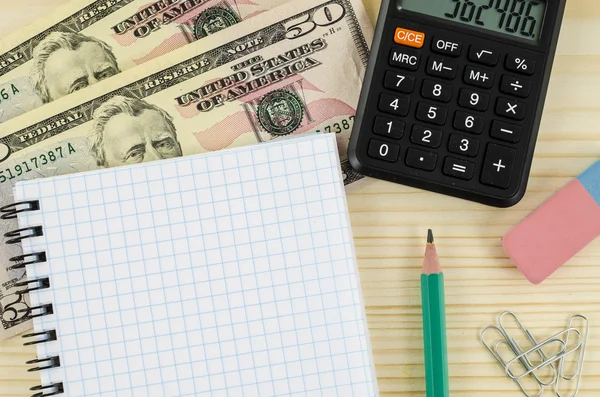 Office, business tools with dollars and calculator on wood table — Stock Photo, Image