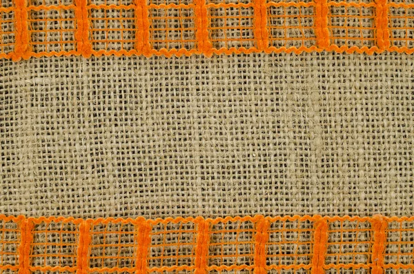 Rama pomarańczowe wstążki na tle płótno — Zdjęcie stockowe