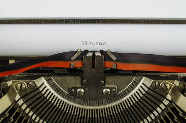Finance word printed on an old typewriter — Stock Photo, Image