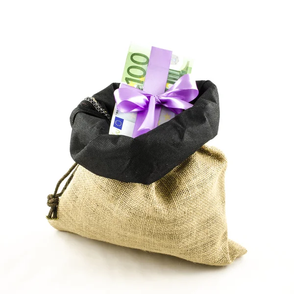 Money with pink bow in jute bag — Stock Photo, Image