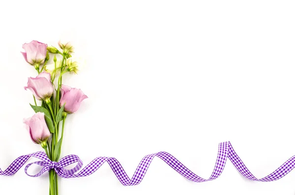 Empty white background with colorful flowers and purple ribbon — Stock Photo, Image