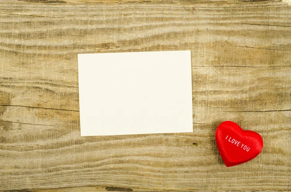 Пустая карточка с сердцем на деревянном столе — стоковое фото