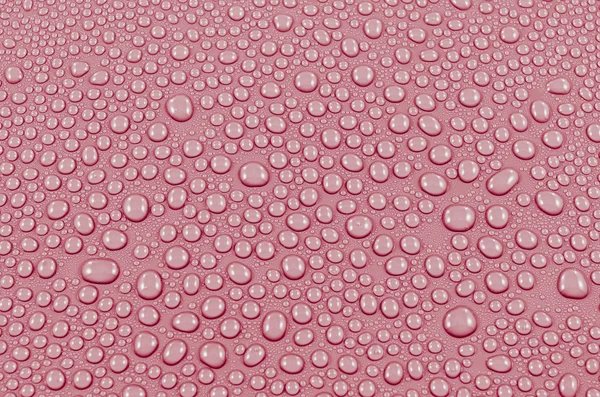 Rote Wassertropfen Hintergrund oder Textur. Nahaufnahme — Stockfoto