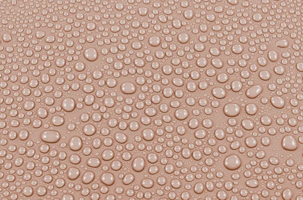 Oranje water druppels achtergrond of textuur. Close-up — Stockfoto