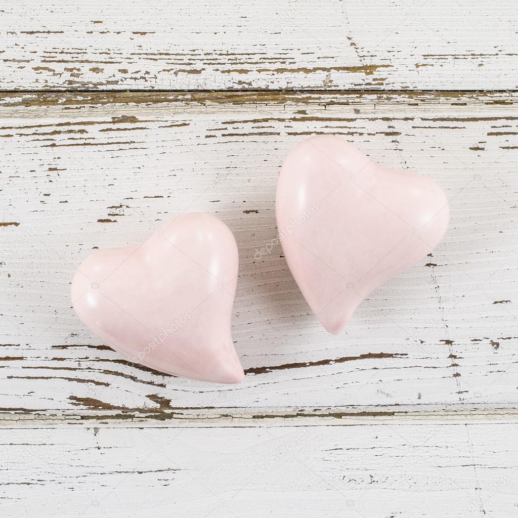 Pink hearts on wooden table