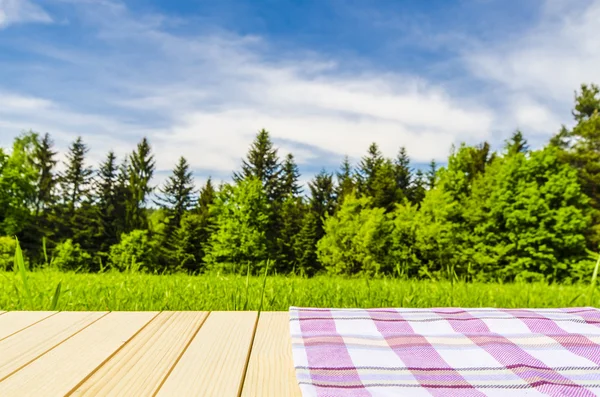 Violet tablecloth on wooden table — Stock Photo, Image