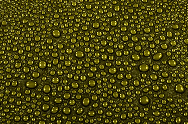 Gele achtergrond met waterdruppels — Stockfoto